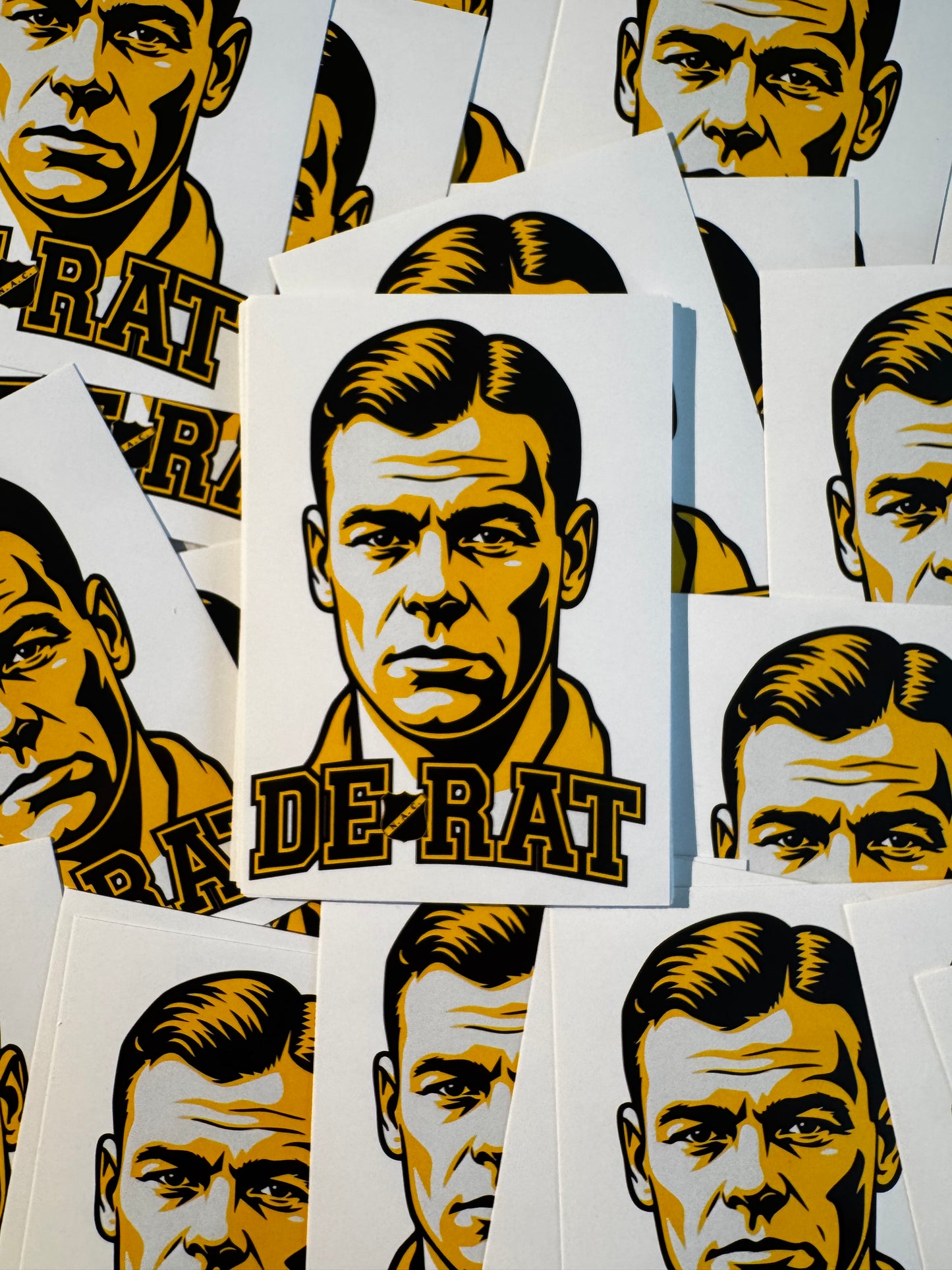 Meerdere NAC Breda stickers met een geel-zwarte illustratie van Rat Verlegh en de tekst "De Rat"