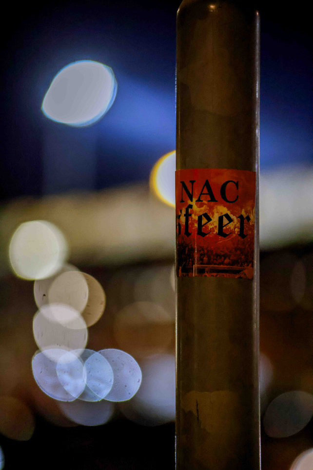 close up van een nacsfeer sticker geplakt op een lantaarnpaal